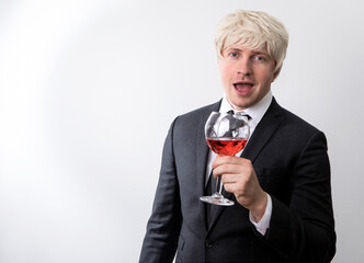 Man hand holding a glass with red wine. Alcohol. Man wine glass. Emotion man face