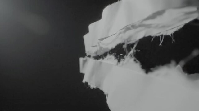 Floating Torn Paper Strips Abstract Black and White Slow Motion