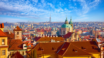 Prague, Czech Republic. Panoramic top view at red roofs skyline of the city. Sunny day with blue sky