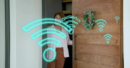 Senior woman opening door as WiFi icons expanding around stepping and welcoming tech creators - Powered by Adobe