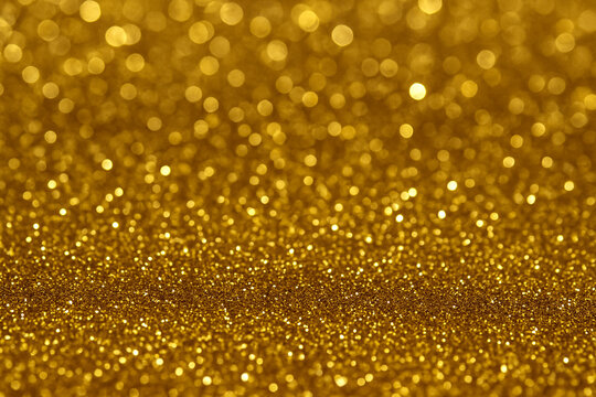 Stunning gold glitter background with sparkling particles and soft bokeh lights. Elegant, festive design banner or holiday card backdrop with copy space  - Powered by Adobe