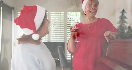 Seated pianist playing piano as standing singer touching keys, holding wine, leading holiday carols