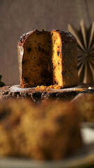 Vertical Close-up of Sliced Panettone with Powdered Sugar and Dramatic Lighting
