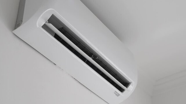 Flat air conditioner split system on white wall in room. closeup