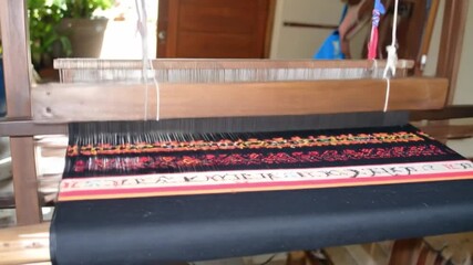 Close up of a wooden loom weaving colorful textile indoors craftsmanship