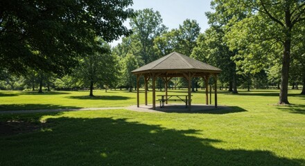 A sunny day at a park, with a wooden gazebo and green lawn