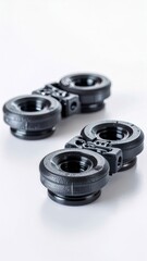 Two black 3D printed threaded plastic parts showing layer lines on a white background