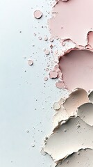 An abstract composition of pastel-colored powder textures, featuring soft pink and beige swirls, splatters, and granular particles against a clean white backgro