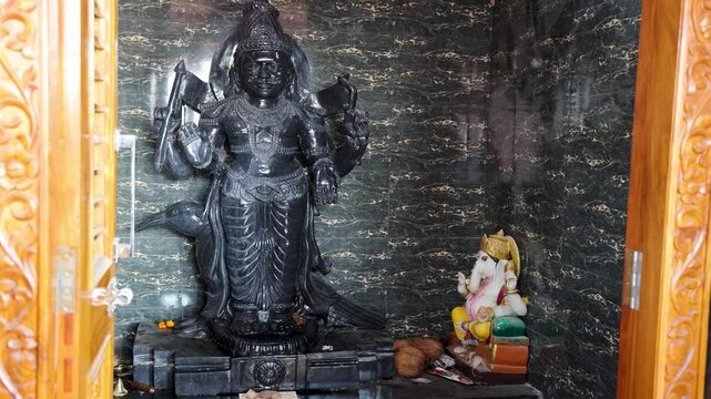 hindu holy black stone shani dev idol placed inside traditional temple