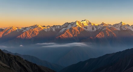 Snowcapped mountains bathed in golden light at sunrise in the himalayas © Mamun