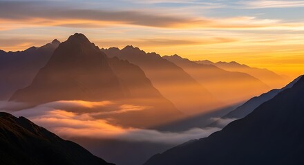 Golden hour illuminates the majestic peaks of the mountain range at sunset
