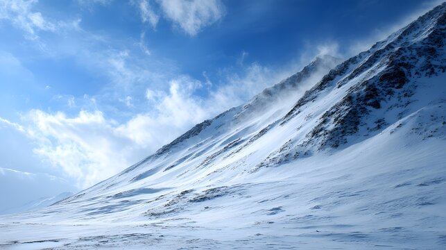 Snowy Mountain Slope with Blowing Snow and Cloudy Sky.