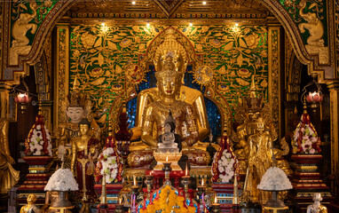 Fototapeta premium Beautiful Buddha images situated in Viharn of Wat Ming Muang an iconic temple in traditional Lanna style located in the centre of Chiang Rai town, Thailand.