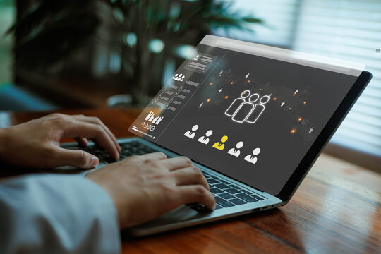 A person working on a laptop with a digital HR dashboard displaying candidate profiles and analytics, representing online recruitment, workforce management, and modern human resources technology.