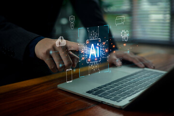 A business professional interacting with a glowing AI hologram above a laptop, representing advanced technology, machine intelligence, automation systems, and digital innovation.