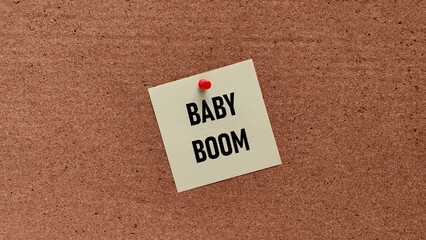 Baby Boom Generation Concept: Sticky Note with Text Pinned to a Brown Cork Board Announcing Population Growth