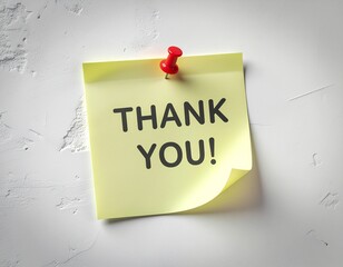 A yellow sticky note with the words "THANK YOU!" pinned to a white wall.