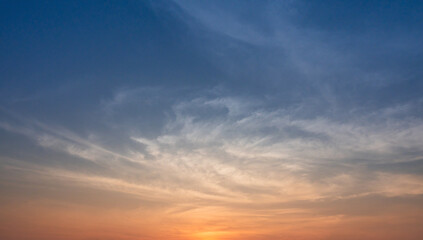 Warm sunrise sky with soft clouds creating a peaceful and calming morning atmosphere.