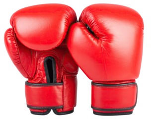 A pair of vibrant red leather boxing gloves sit ready, isolated against a black backdrop