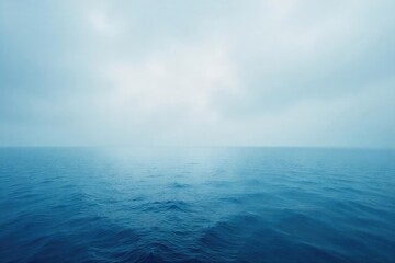 Obraz premium Vast, endless ocean meeting the hazy horizon, a tranquil scene of blue and grey under a calm sky Perfect for travel, nature, and serenity themes , marine, day