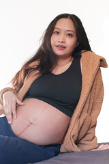 Tender maternal woman makes heart gesture on her belly. Important health consultation for new life and pregnancy