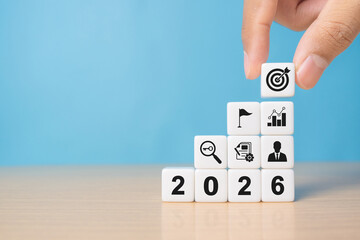 Business management and financial concept. 2026 goal and target. Hand pick dartboards with 2026 number for set strategy and plan for future