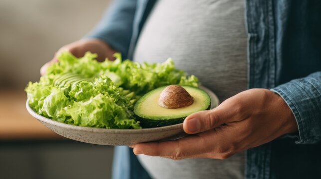 Close-up of Belly Next to Healthy Salad and Avocado Showcasing Diet Versus Obesity Concept