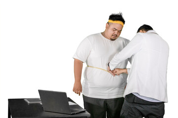 Asian doctor measuring waist of obese man with tape, isolated on white background
