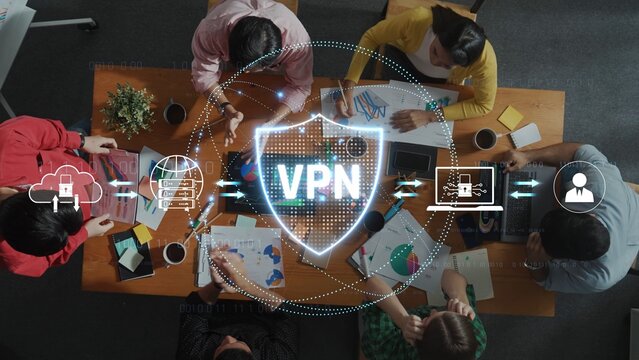 A group of professionals collaborates around a table, showcasing a VPN security concept to emphasize data protection and network privacy in a modern office setting. Raster