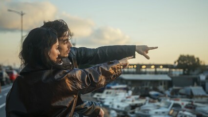 Naklejka premium Couple Enjoying Sunset at Marina Pointing Together