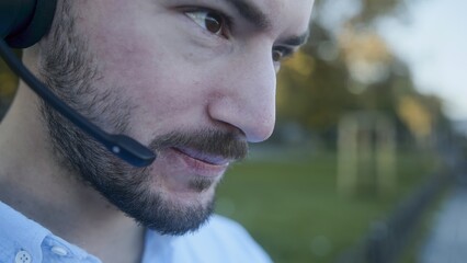 Close-up of a Man with Headset in Outdoor Setting