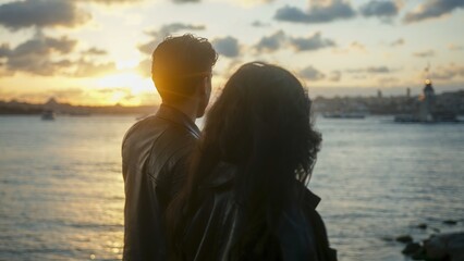 Couple Watching Sunset by the Water