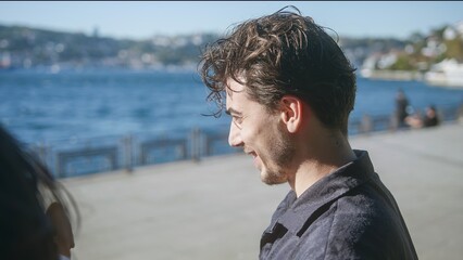 Man Smiling by the Water in Bright Sunshine