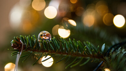 Festive holiday atmosphere with Christmas tree branch and blurred lights