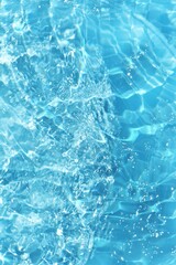 Blue water with ripples on the surface. Defocus blurred transparent blue colored clear calm water surface texture with splashes and bubbles. Water waves with shining pattern texture background.