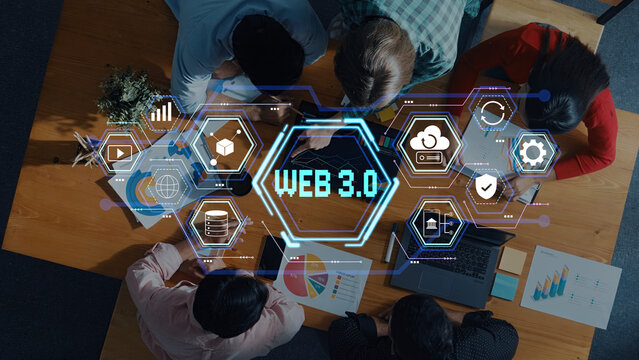 A diverse group of professionals collaborates on Web 3.0 technology projects, surrounded by icons and data visualizations, showcasing innovation and teamwork. Trope - Powered by Adobe