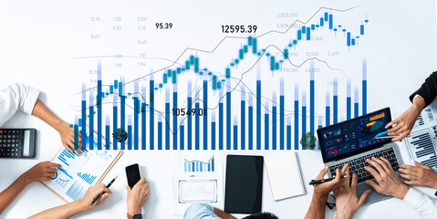 Diverse group analyzing financial data with charts and graphs on various devices in a modern workspace, showcasing collaboration in business insights and strategies. Scalp
