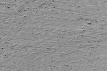 Close-up texture of old, uneven, rough grey plaster.