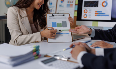 Businesswoman presenting financial data to male colleague
