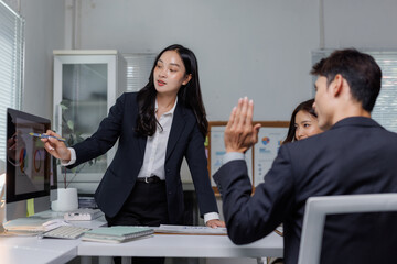 Businesswoman presenting data to colleagues during meeting