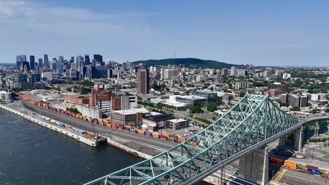 Aerial view of Montreal city skyline and the Jacques Cartier Bridge over the St. Lawrence with downtown in the background. g.
