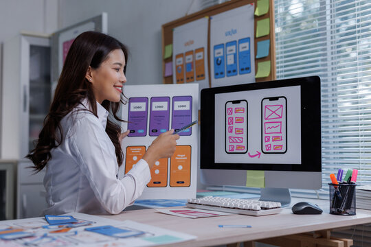 Woman designing mobile application interface prototypes - Powered by Adobe
