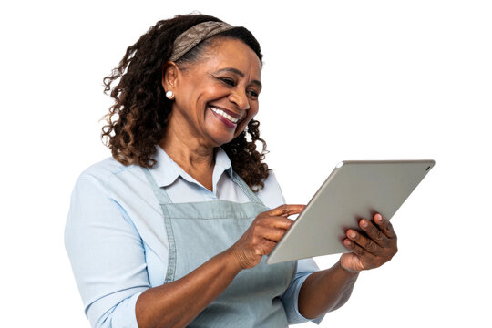 Smiling Black woman wearing an apron and headband uses a tablet for business or personal tasks, suitable for marketing, technology, or service industry applications.