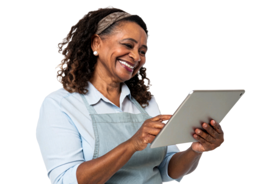 Smiling Black woman wearing an apron and headband uses a tablet for business or personal tasks, suitable for marketing, technology, or service industry applications. - Powered by Adobe