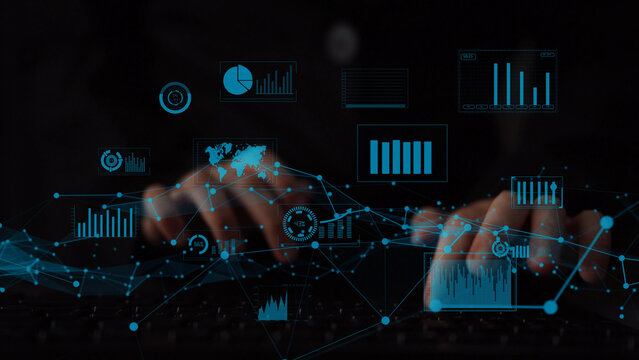 A close-up view of hands typing on a keyboard, surrounded by glowing digital graphs and charts. This image represents data analysis and business intelligence in a modern workspace. Xenic