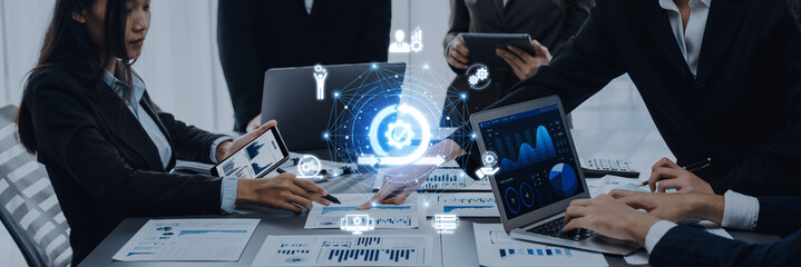 Business professionals in a modern office collaborate on data analysis through digital technology, showcasing teamwork, innovation, and strategic planning. Trope