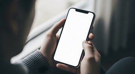 Hands holding a modern smartphone with a blank white screen device mockup for app presentation isola