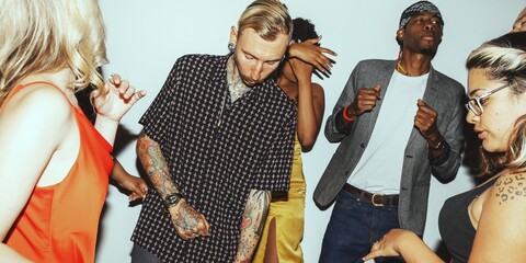 Group of diverse people dancing at a party. Energetic dance moves, lively atmosphere, and diverse crowd enjoying the music and fun. Friends dancing at a party.