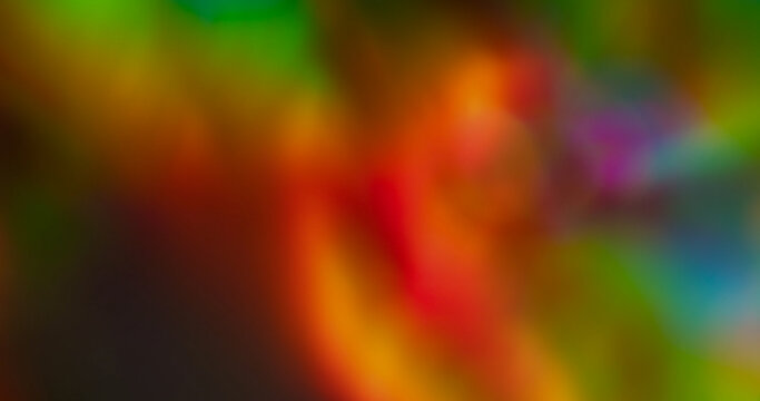 Defocused glow. Reflection leak. Red green colorful neon glossy texture illuminated abstract red orange vibrant twinkle on dark background.