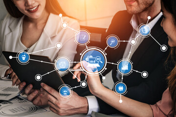 A business team engages with a tablet, showcasing technology icons that signify digital communication and collaborative work in a contemporary office setting. Tessel